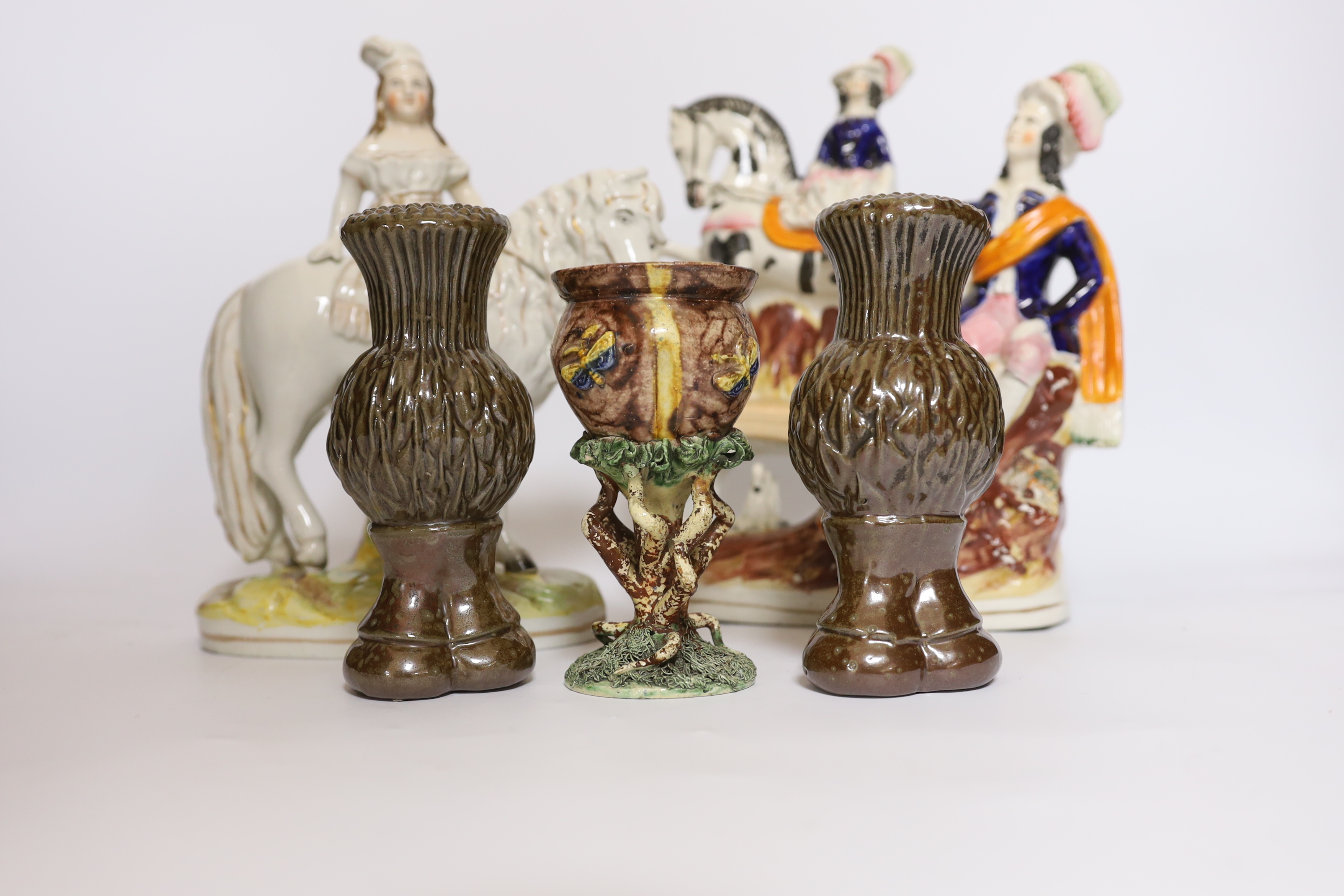 A rare Staffordshire horse group, a Princess Royal and pony group, a Palissy ware vase and a pair of stoneware thistle curtain finials, tallest 25cm